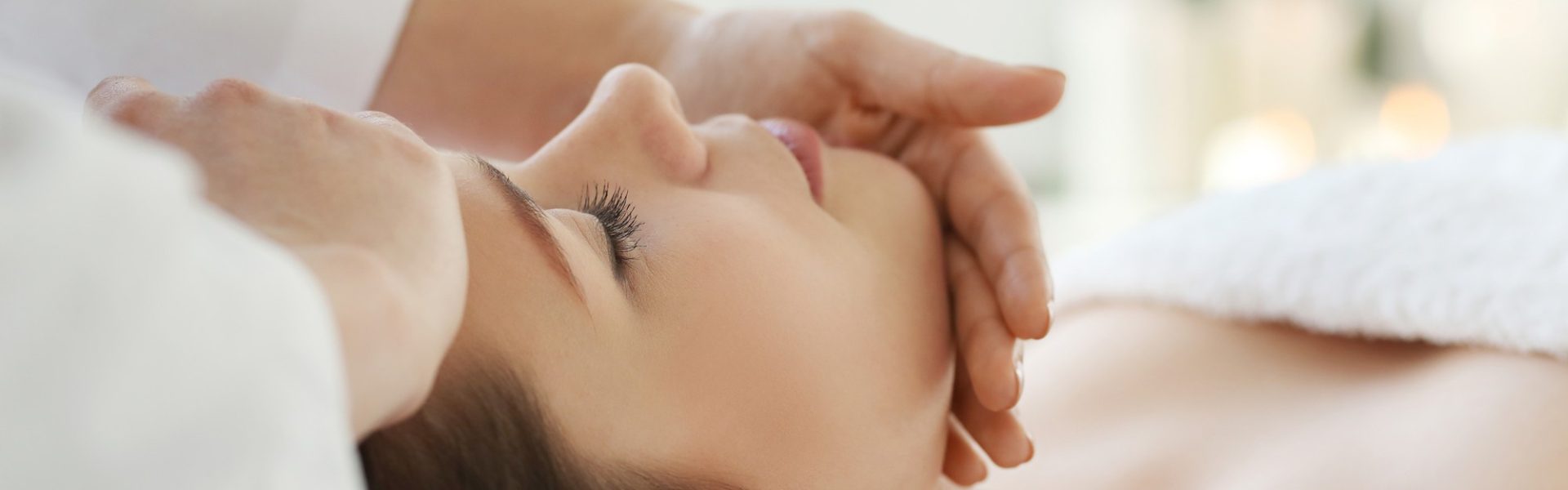 lying-woman-receiving-a-massage-craniosacral-therapy