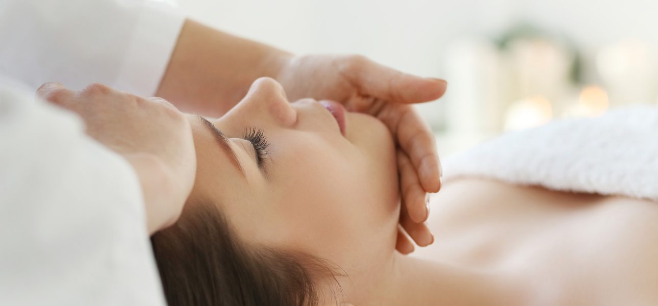 lying-woman-receiving-a-massage-craniosacral-therapy lying-woman-receiving-a-massage-craniosacral-therapy